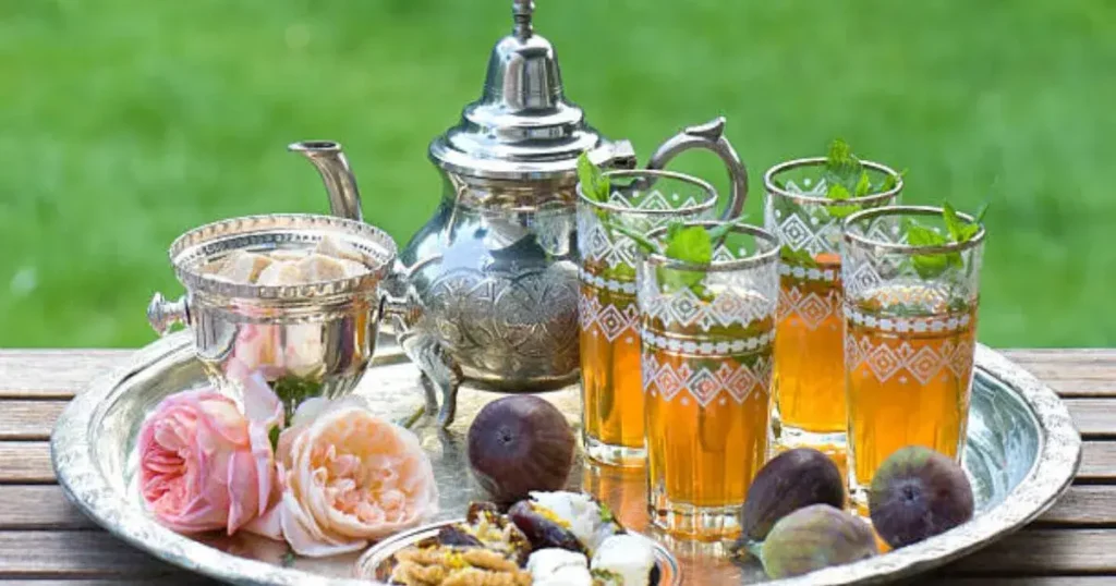 Authentic Moroccan Mint Tea served in traditional glasses with fresh spearmint in Marrakech riad