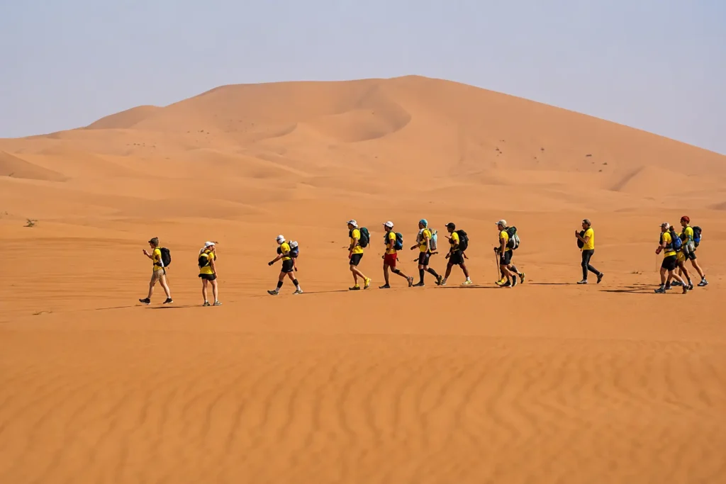 Group of runners competing in a desert ultra marathon race in the Sahara