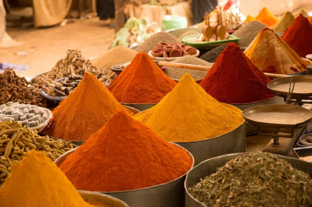 Colorful spice stalls in a Marrakech souk representing Moroccan market traditions
