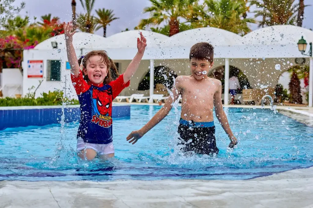Children playing at Oasiria water park wave pool near Marrakech
